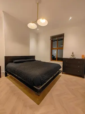 a bedroom with a bed and a dresser and a window at Casa Rocío in Liverpool