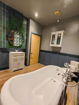a white bath tub in a bathroom with a door at Casa Rocío in Liverpool