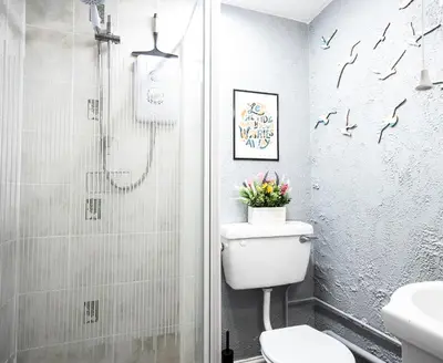 a bathroom with a toilet and a shower at St Andrews by Guestz in Lytham St Annes