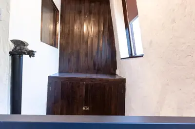 a wooden door in a room with a window at St Andrews by Guestz in Lytham St Annes