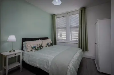 a small bedroom with a bed and a window at Comfy 3-Bed, Sleeps 5 & Parking in Blackpool