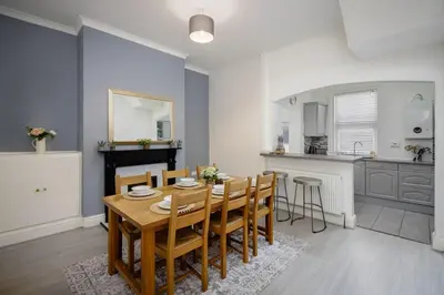 a dining room and kitchen with a table and chairs at Comfy 3-Bed, Sleeps 5 & Parking in Blackpool