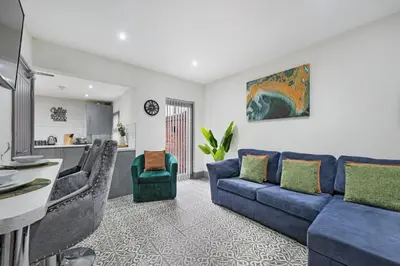 a living room with a blue couch and chairs at Sutcliffe House - Air Host & Stay - 3 bed 3 bath - Contractor Friendly in Liverpool
