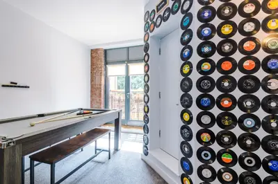 a wall of wine bottles in a room with a pool table at Pool Table, Stunning 2Bed Apt, Central Location in Liverpool