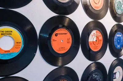 a bunch of vinyl records lined up on a wall at Pool Table, Stunning 2Bed Apt, Central Location in Liverpool