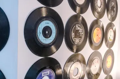 a bunch of records lined up on a wall at Pool Table, Stunning 2Bed Apt, Central Location in Liverpool
