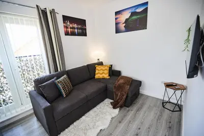 a living room with a couch and a window at Ampee Guest Suite-Free Parking in Liverpool