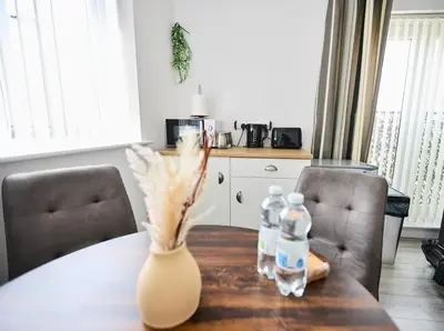a dining room table with two bottles of water at Ampee Guest Suite-Free Parking in Liverpool
