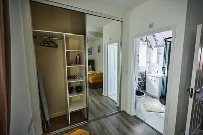 a bathroom with a mirror and a toilet in a room at Ampee Guest Suite-Free Parking in Liverpool