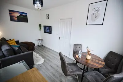 a living room with a table and chairs at Ampee Guest Suite-Free Parking in Liverpool
