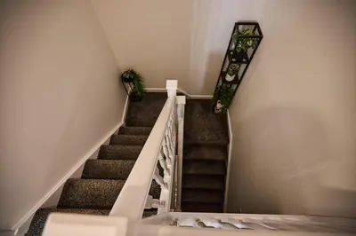 a staircase with two potted plants on the wall at Ampee Guest Suite-Free Parking in Liverpool