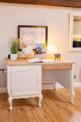 a desk in a room with a picture on the wall at The Lodge at Greenbank Farm
