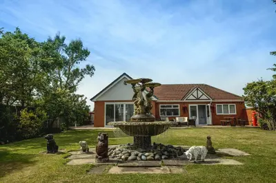 a fountain in the front yard of a house at Finsters Retreat in Ainsdale