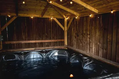 a room with a bath tub with lights in it at Finsters Retreat in Ainsdale