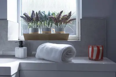 a towel on a counter in a bathroom with a window at Finsters Retreat in Ainsdale