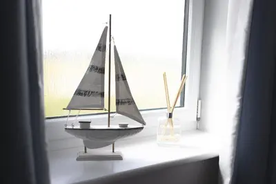 a toy boat sitting on a window sill at Finsters Retreat in Ainsdale