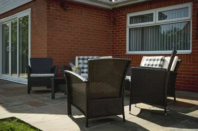 a group of chairs and tables on a patio at Finsters Retreat in Ainsdale