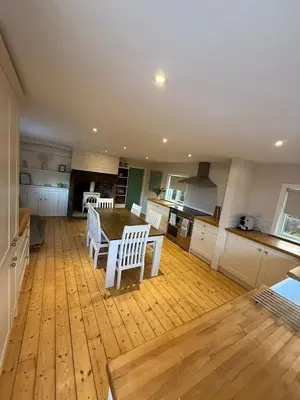 a large kitchen with a wooden table and chairs at 1 Top Locks Cottage in Burscough