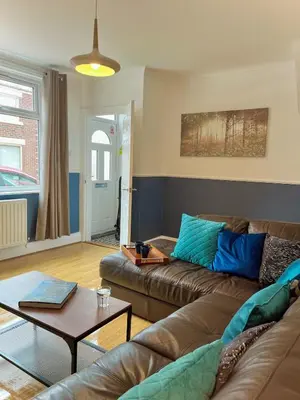 a living room with a couch and a table at Your ideal 3-bedroom home to stay in Leyland in Leyland