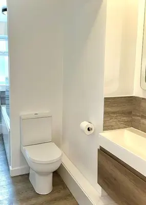 a white bathroom with a toilet and a sink at Your ideal 3-bedroom home to stay in Leyland in Leyland