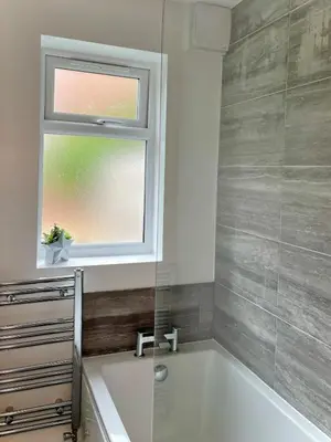 a bathroom with a bath tub and a window at Your ideal 3-bedroom home to stay in Leyland in Leyland
