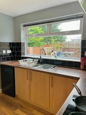 a kitchen with a sink and a window at Your ideal 3-bedroom home to stay in Leyland in Leyland