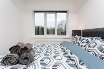 a bedroom with a bed with towels on it at Preston 4 bedroom house near M55 & M6 in Woodplumpton