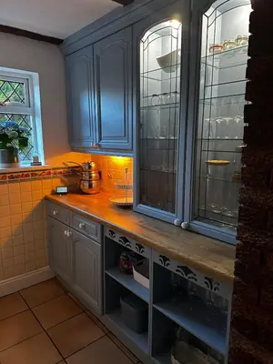 a kitchen with blue cabinets and a counter top at Beautiful apartment at field view cottage in Eccleston