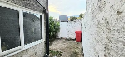 an alley with a window next to a building at Comfortable 3BR - Sleeps 5 - Fast WiFi -Parking in Barrow in Furness