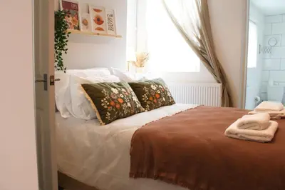 a bedroom with a bed with pillows and a window at #55 Spacious2BR End-Terrace in Kensington Sleeps 6 in Liverpool