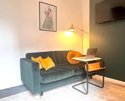 a living room with a couch and a table with a laptop at #55 Spacious2BR End-Terrace in Kensington Sleeps 6 in Liverpool