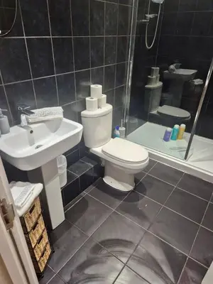 a bathroom with a toilet and a sink and a shower at #49 Luxury 4-Bedroom House with Modern Comforts in Liverpool
