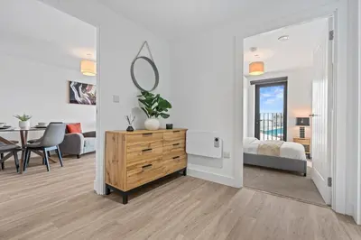 a white living room with a bedroom and a table at Liverpool City Stay 2BR Apartment Sleeps 3 in Liverpool