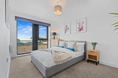 a bedroom with a bed and a large window at Liverpool City Stay 2BR Apartment Sleeps 3 in Liverpool