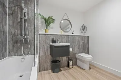 a bathroom with a sink and a toilet and a bath tub at Liverpool City Stay 2BR Apartment Sleeps 3 in Liverpool