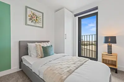 a white bedroom with a bed and a window at Liverpool City Stay 2BR Apartment Sleeps 3 in Liverpool