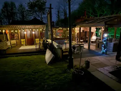 a house with christmas lights in a yard at night at Fitzys Apartment Wellness Retreat