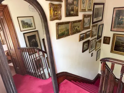 an archway in a hallway with pictures on the wall at Fitzys Apartment Wellness Retreat