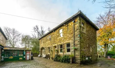 an old brick building on a cobblestone street at Fitzys Coach House - Wellness Retreat