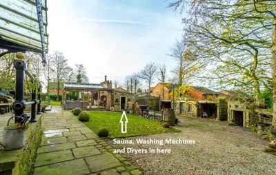 a house with a garden with a sign that says sunshine washing machines and dogs in at Fitzys Coach House - Wellness Retreat