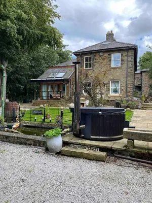 a house with a hot tub in front of it at Fitzys Coach House - Wellness Retreat