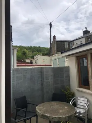 a patio with a table and chairs on a balcony at Fitzys Terrace Three Bed in Accrington