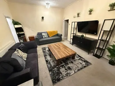a living room with a couch and a coffee table at Oswaldtwistle Spacious 3 Bedroom Two Bath in Oswaldtwistle
