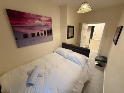 a bedroom with a bed with a towel on it at Oswaldtwistle Spacious 3 Bedroom Two Bath in Oswaldtwistle