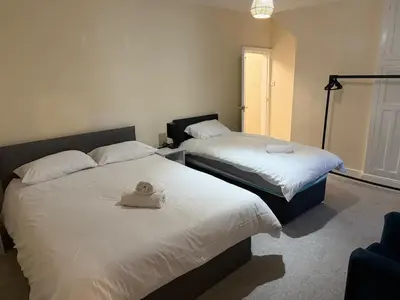 a bedroom with two beds with a hat on them at Oswaldtwistle Spacious 3 Bedroom Two Bath in Oswaldtwistle