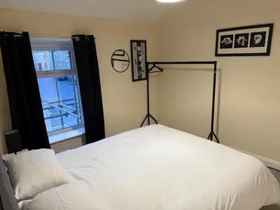 a bedroom with a white bed and a window at Oswaldtwistle Spacious 3 Bedroom Two Bath in Oswaldtwistle