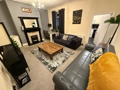 a living room with a couch and a coffee table at Oswaldtwistle Spacious 3 Bedroom Two Bath in Oswaldtwistle