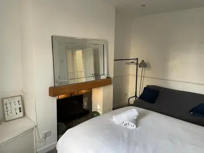 a bedroom with a bed and a mirror on the wall at Accrington Three Bed in Accrington