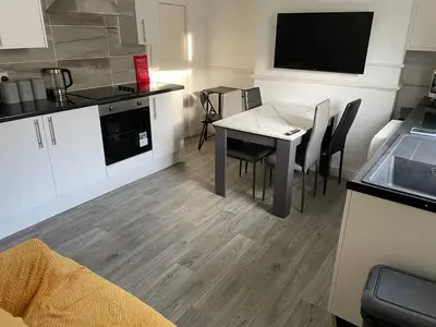 a kitchen and dining room with a table and chairs at Accrington Three Bed in Accrington