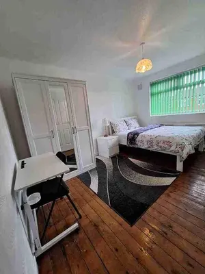 a bedroom with a bed and a table in it at Liverpool Rooms Near City & Stadiums in Liverpool
